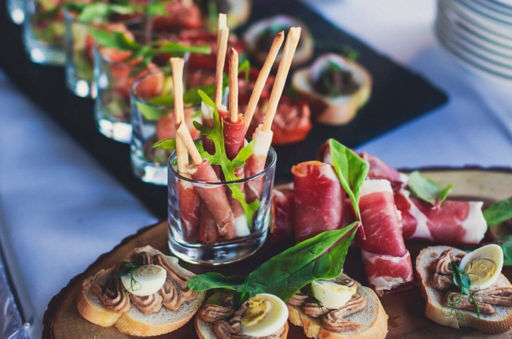 Decorated catering banquet table with different food appetizers assortment on a party